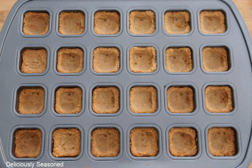 A 34-count mini muffin tin with Oreo cookie crusts in each opening.