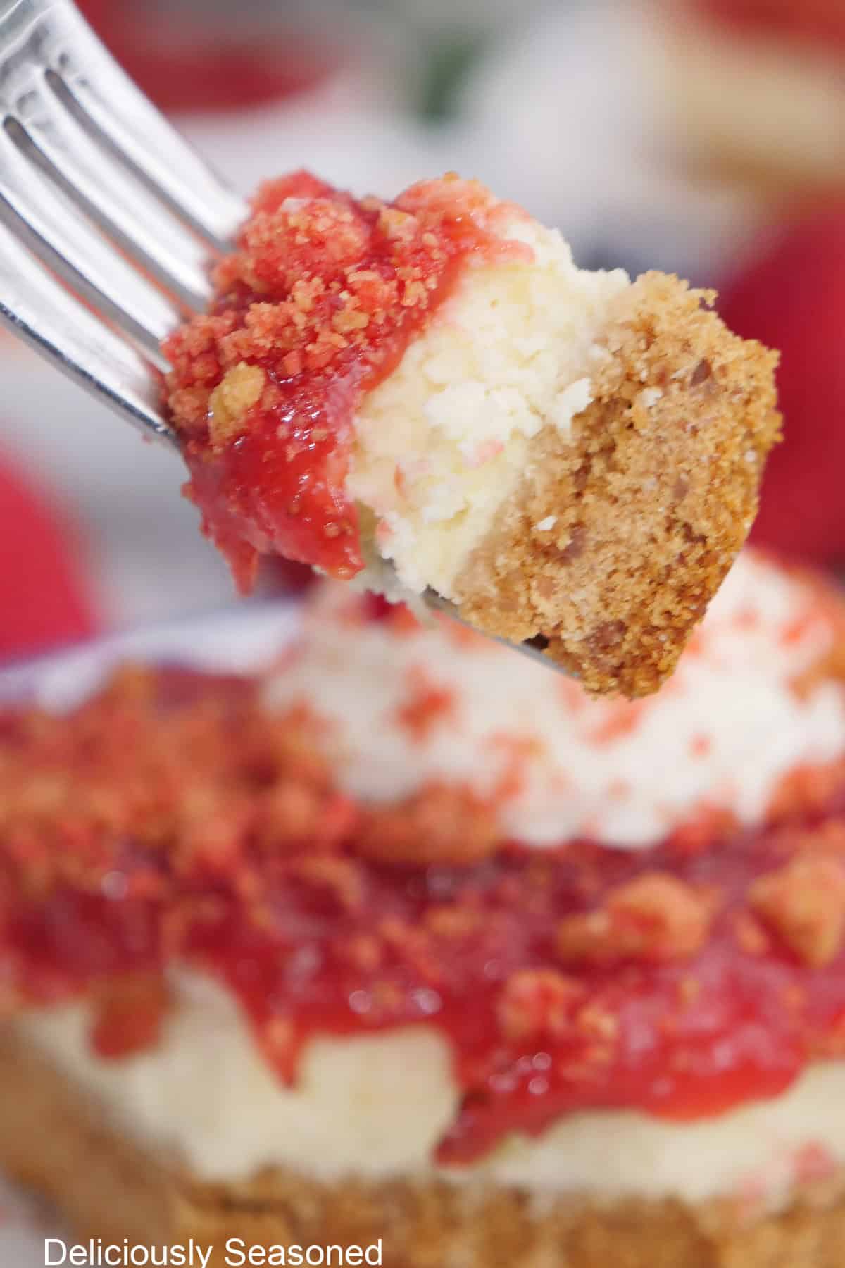 A bite of strawberry cheesecake bars on a fork.