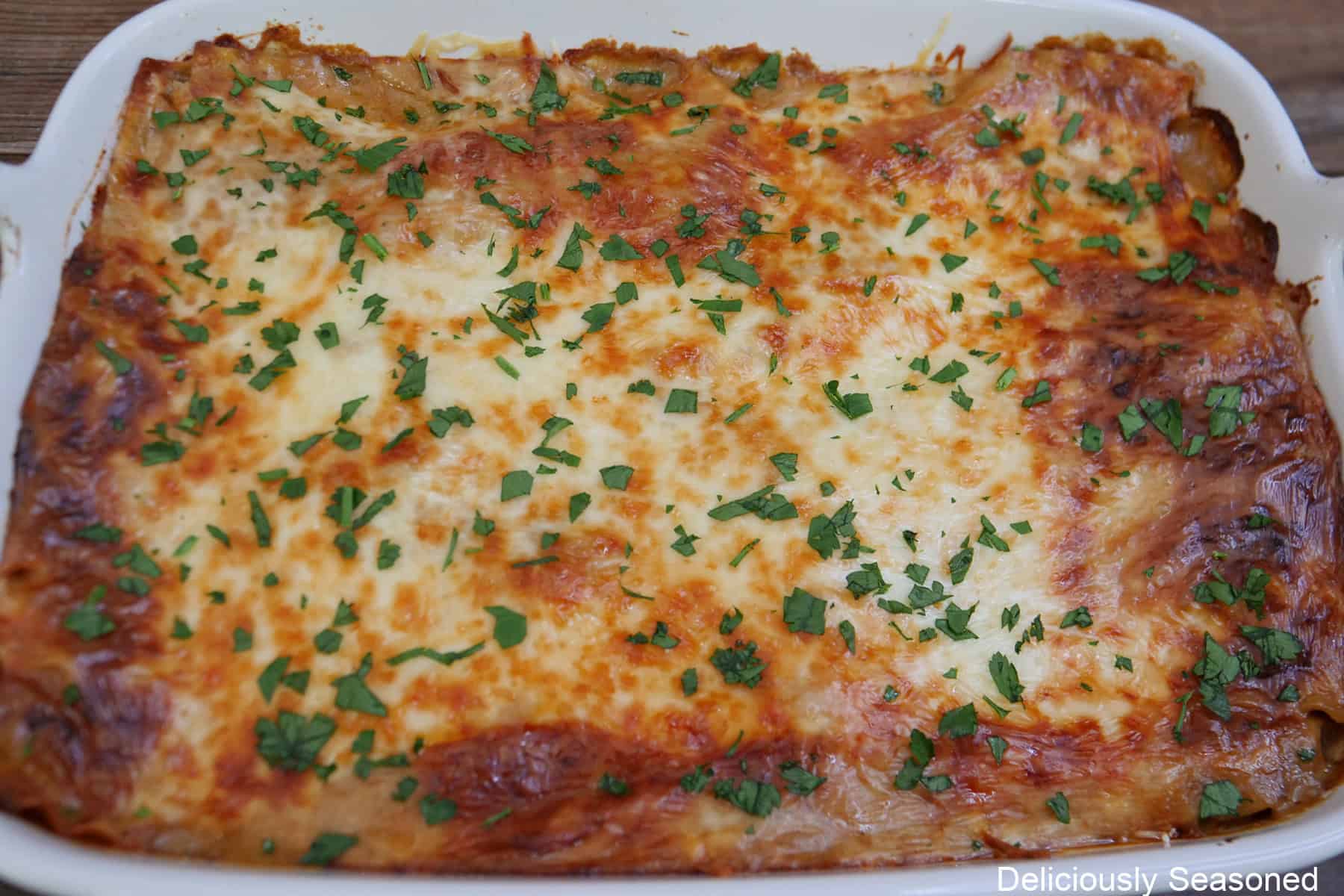 A baking dish with a baked beef stroganoff lasagna in it.