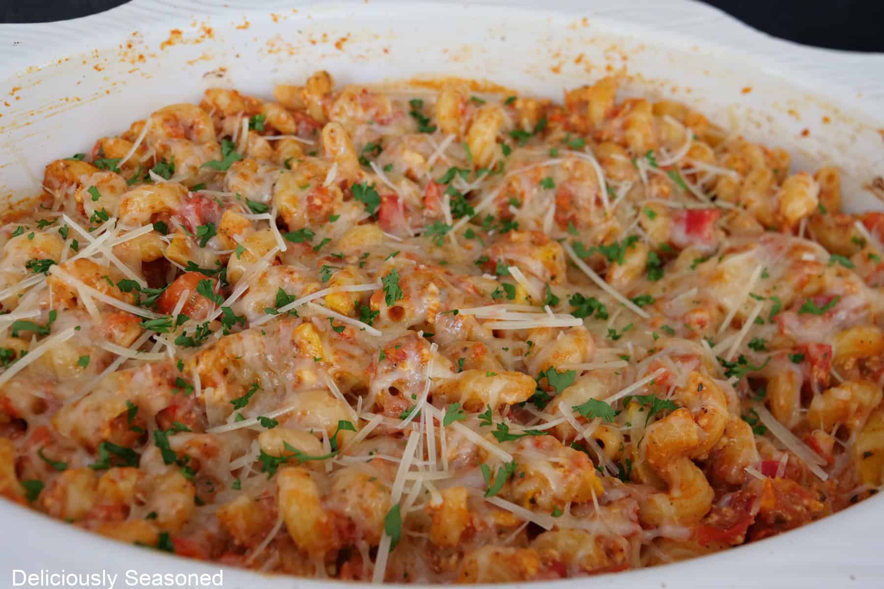 A white baking dish with the feta tomato mixture in it after being pulled from the oven.