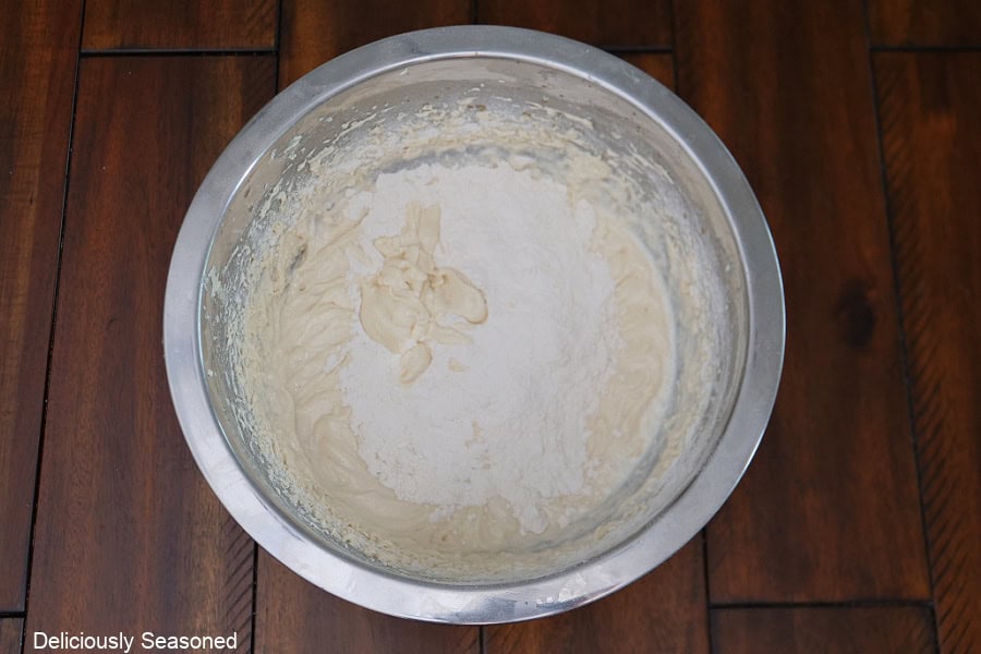 A wood surface with cake batter in it before being completely mixed together.