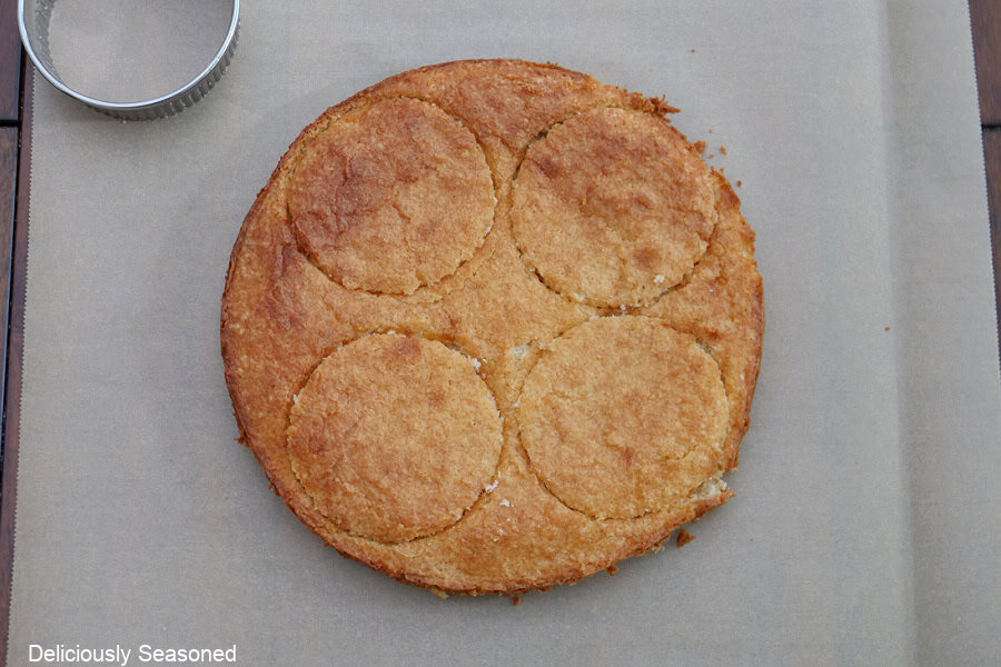 A round baked cake with four round circles cut out of it to be used for the parfaits.