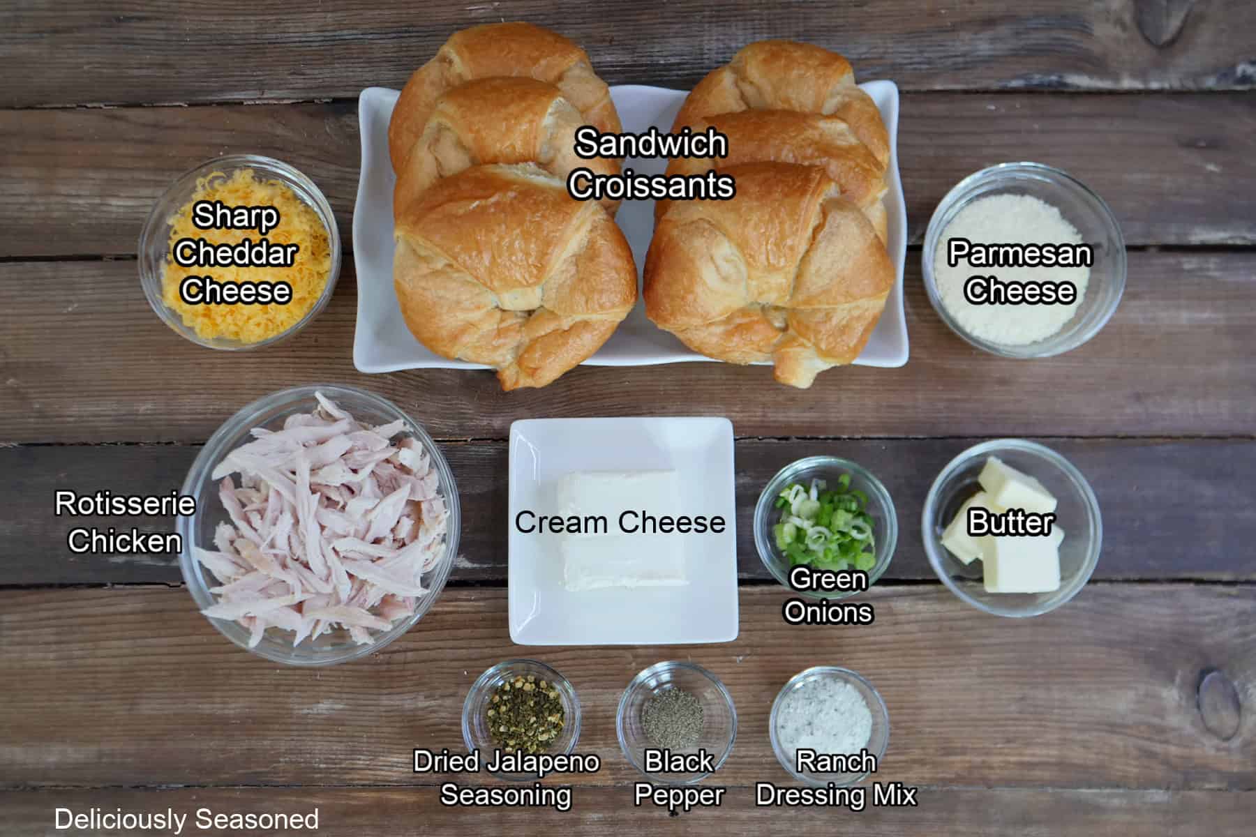 A wood surface with all the ingredients placed on it to make chicken ranch crusted croissants.