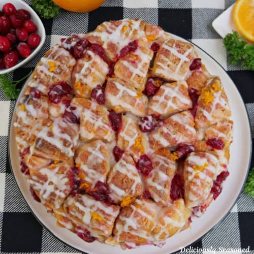 A black and white checkered placemat with a cranberry orange monkey bread placed on it.