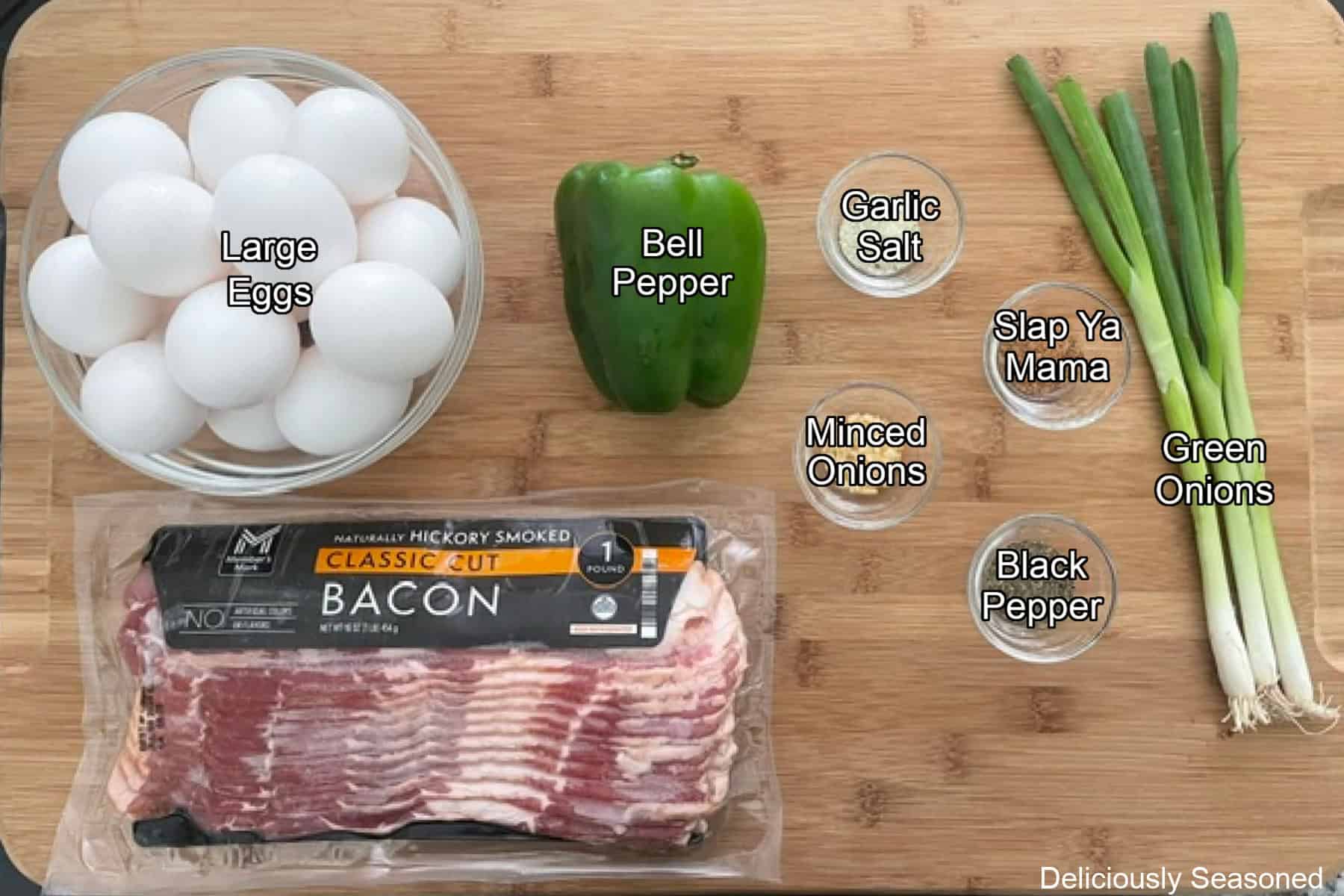 A wood surface with all the ingredients placed on it to make bacon egg bites.