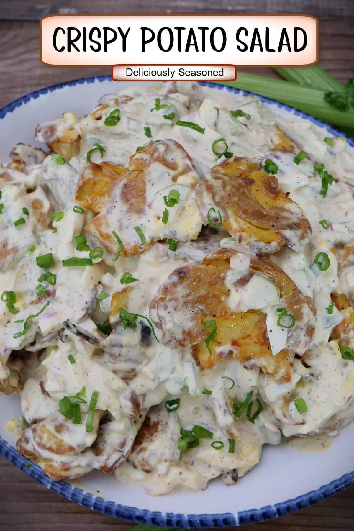 A white bowl with blue trim filled with a serving of crispy potato salad, and a title overlay at the top.