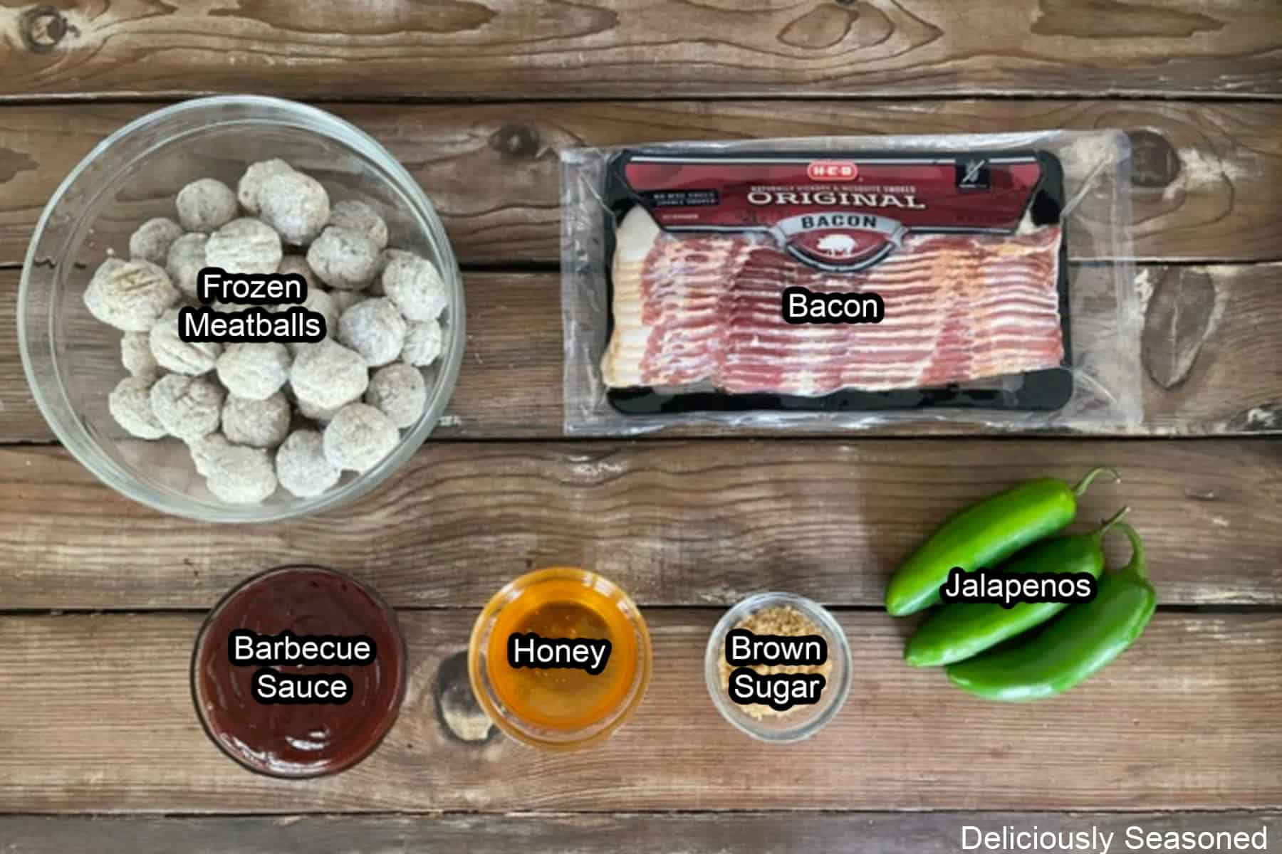 A wood surface with all the ingredients placed on it to make smoked bacon wrapped meatballs.