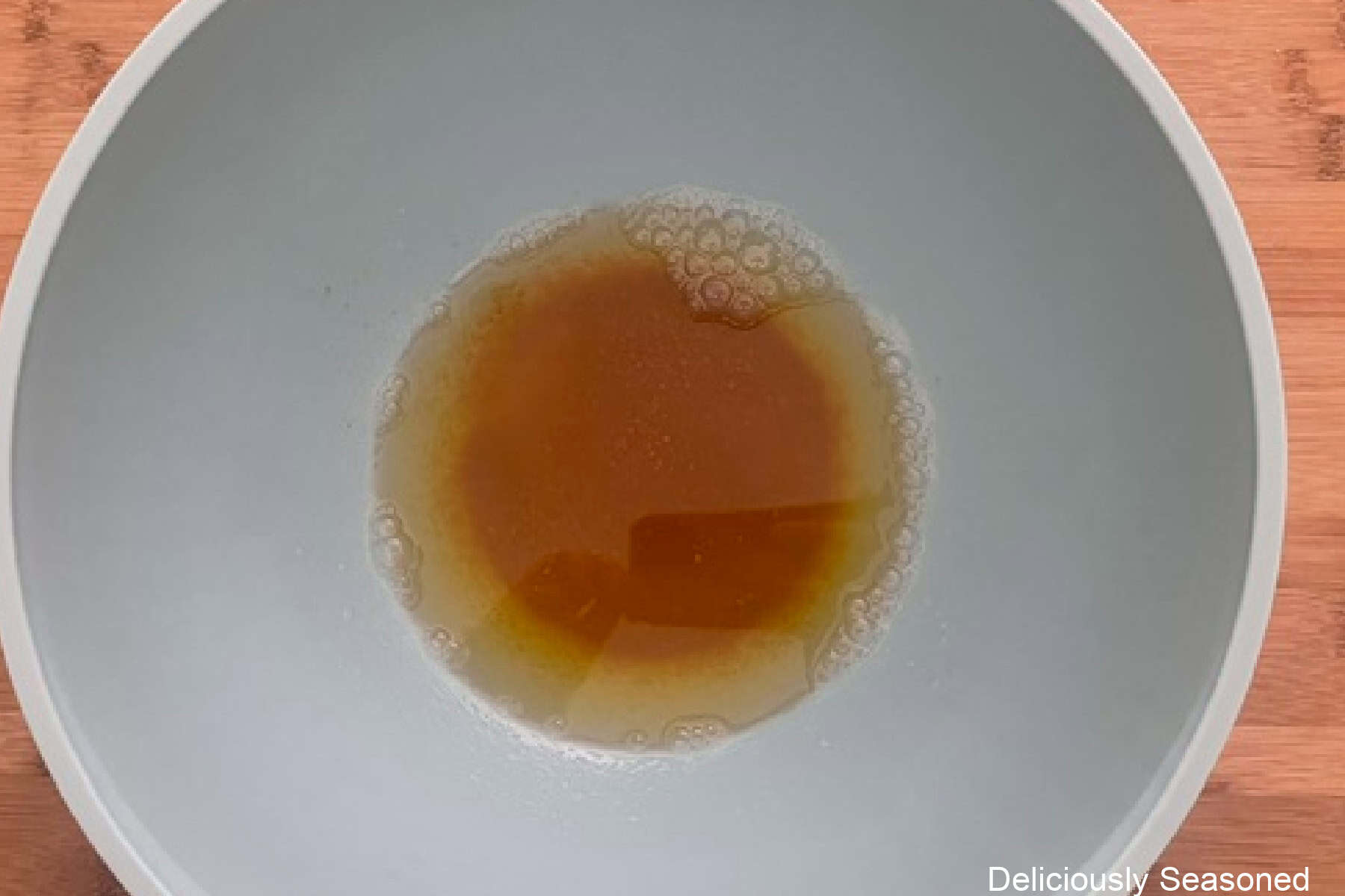 A mixing bowl with browned butter in it.