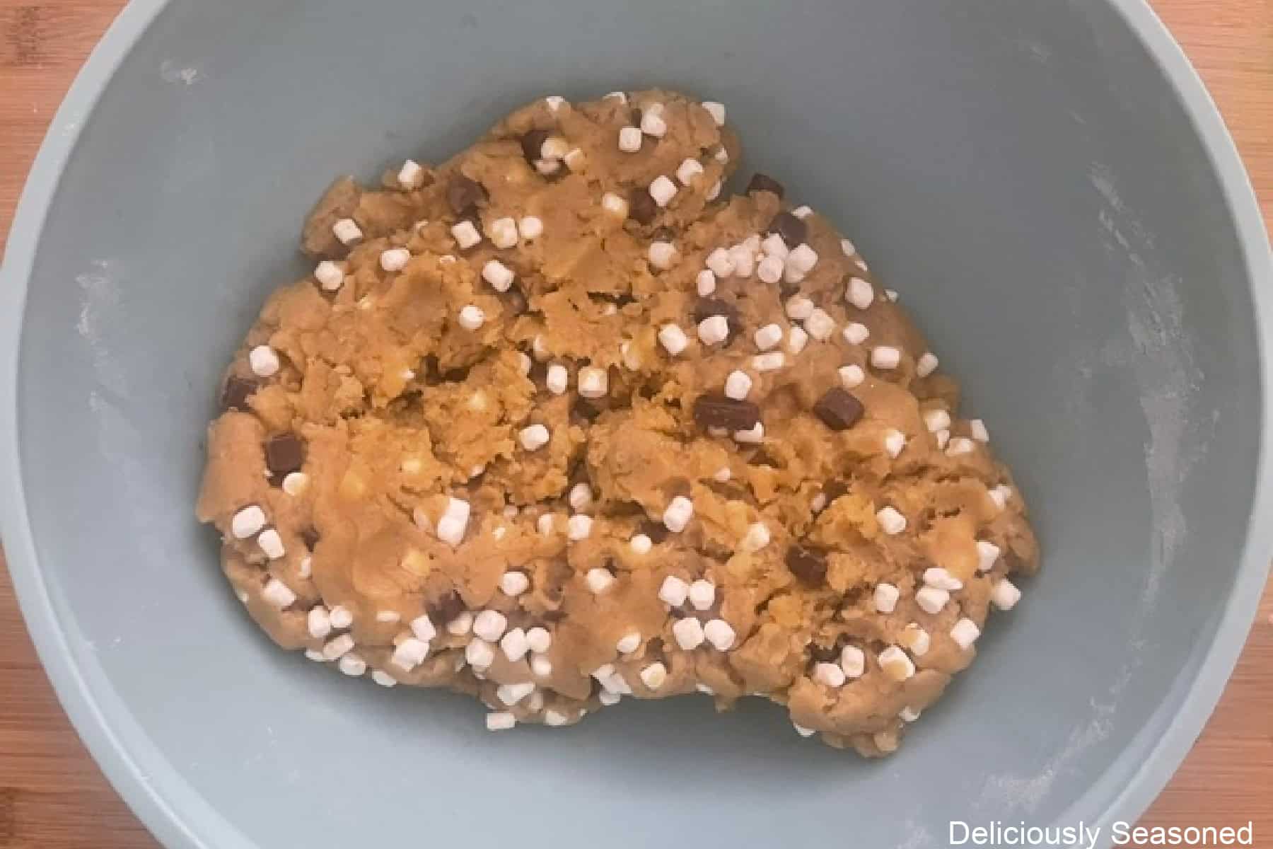 A mixing bowl with s'mores cookie batter in it.