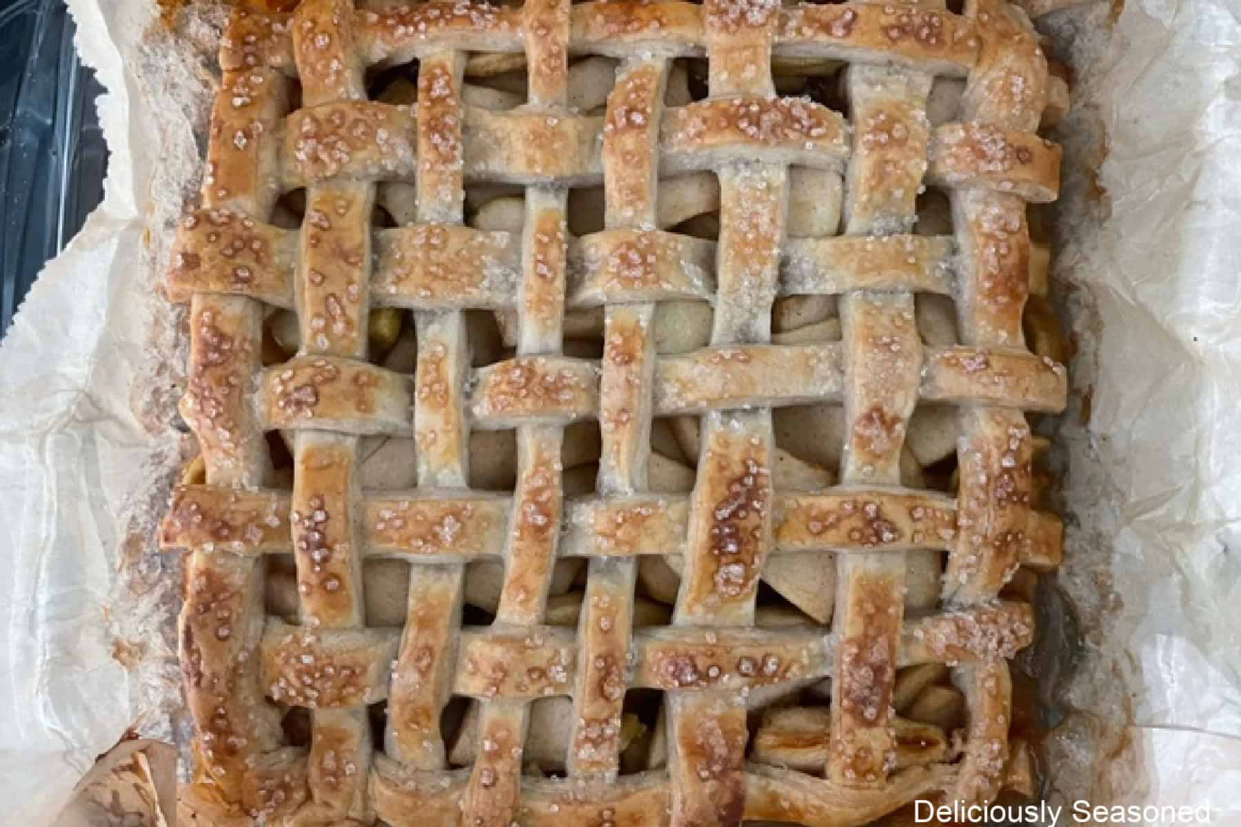 A baked apple pie bar recipe showing the golden brown lattice top.