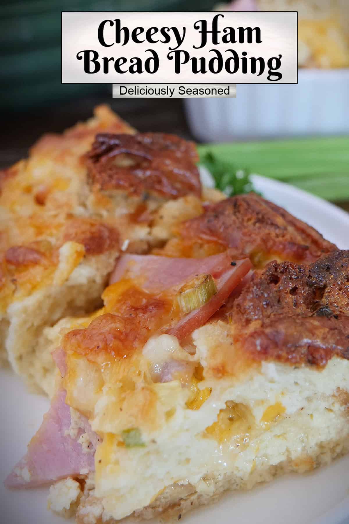 A serving of cheesy ham bread pudding on a white plate with a title overlay at the top.
