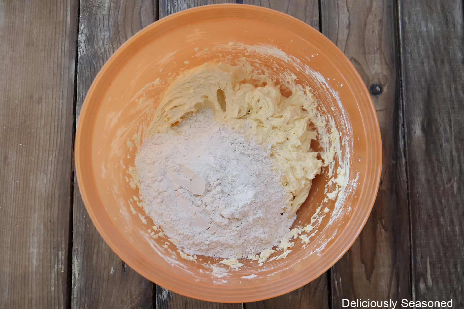 Bundt cake batter with the flour mixture added on top before being combined.