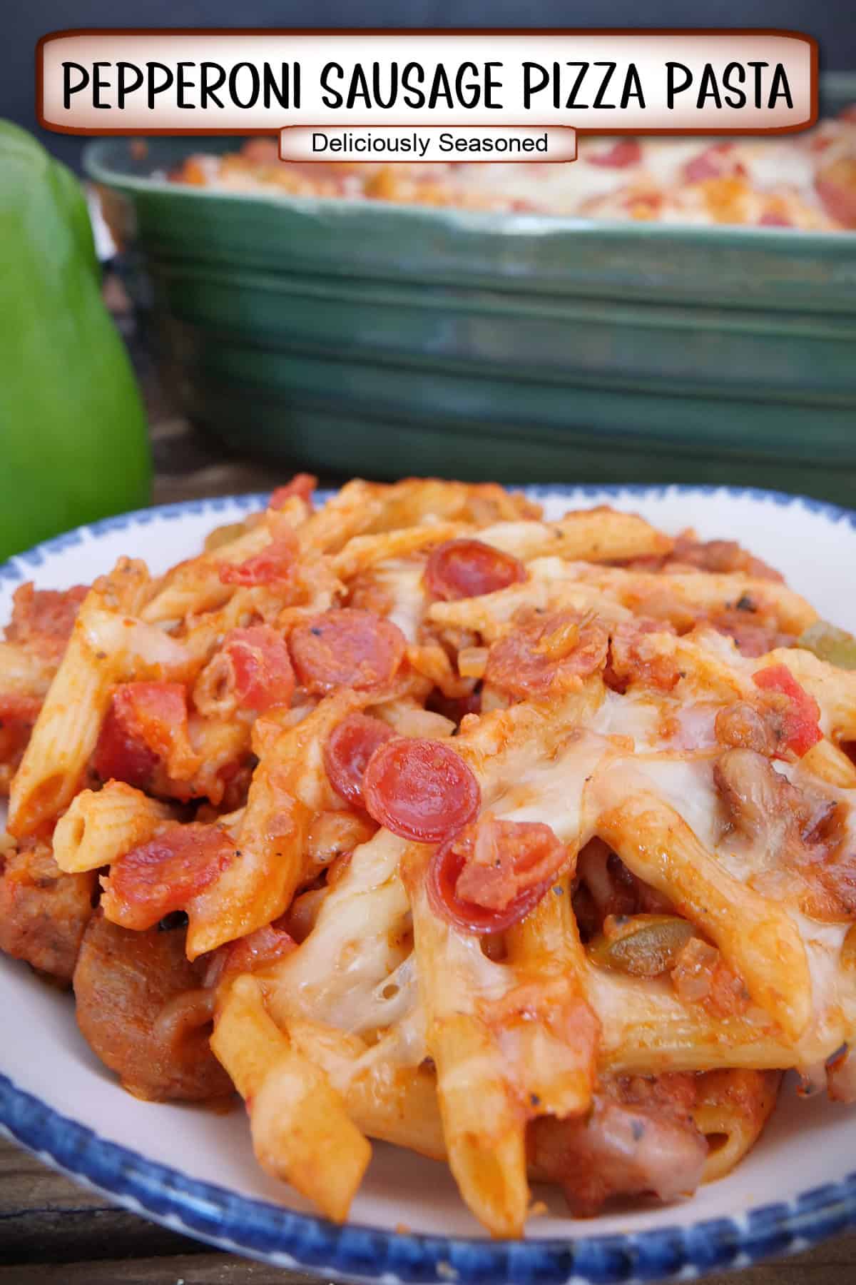 A white bowl with blue trim with a serving of pepperoni sausage pizza pasta in it with a title overlay at the top.