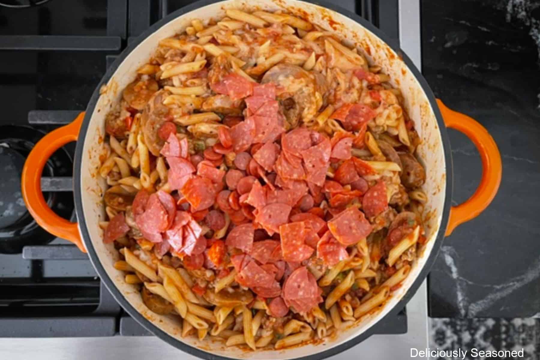 A frying pan with Italian sausage pasta sauce with pepperoni added.