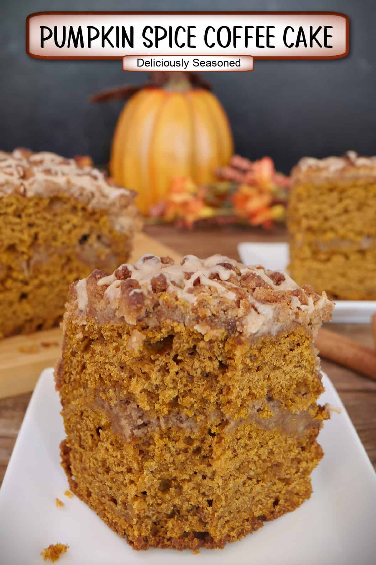 A slice of pumpkin spice coffee cake on a white plate with a title overlay at the top.