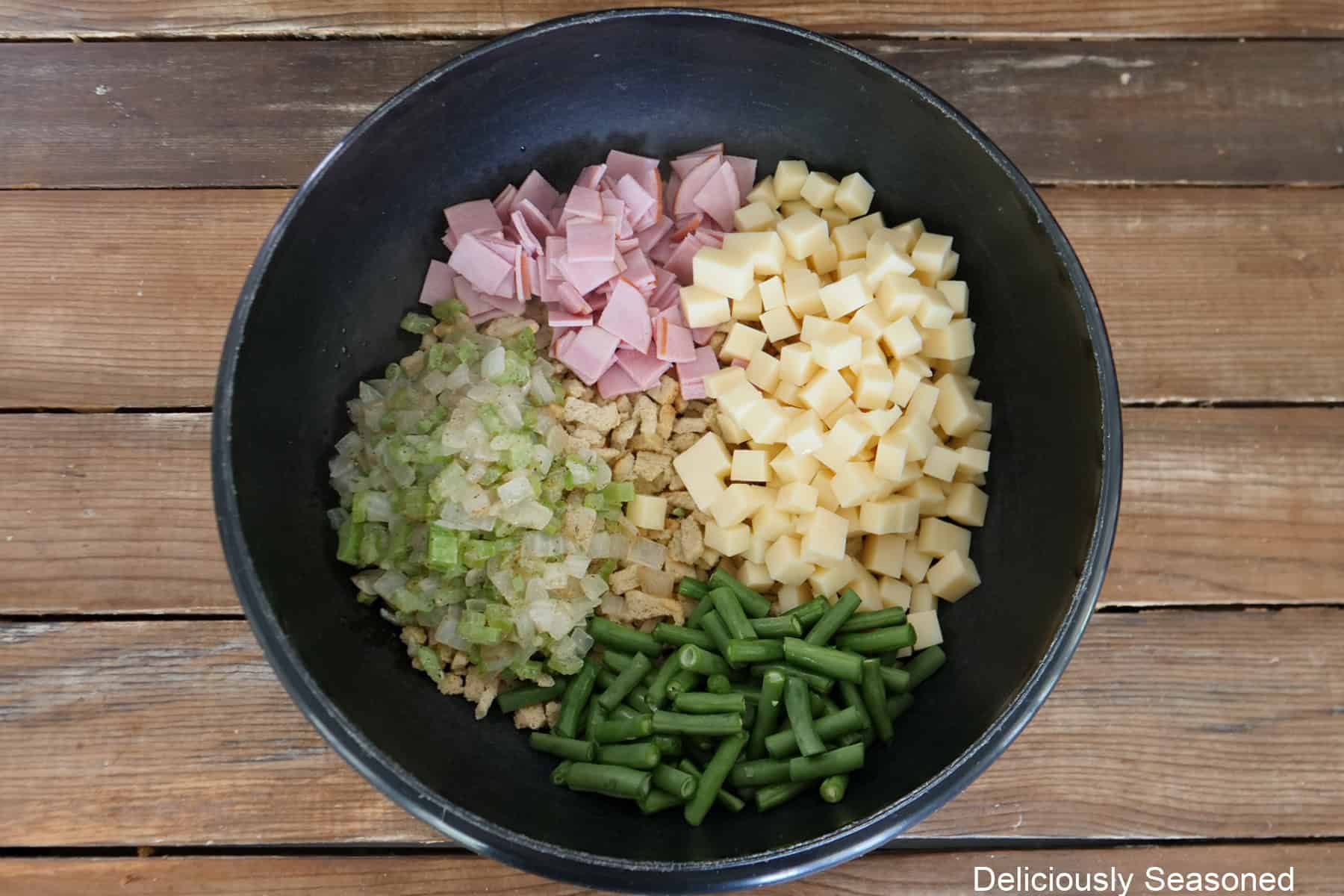 A black bowl with all the ingredients placed in it before being combined together.