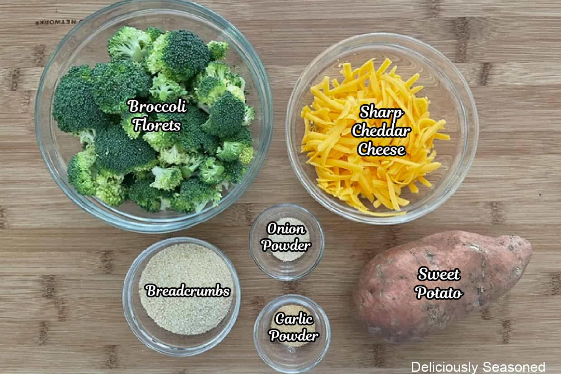 A wood surface with all the ingredients placed on it to make sweet potato broccoli cheddar fritters.
