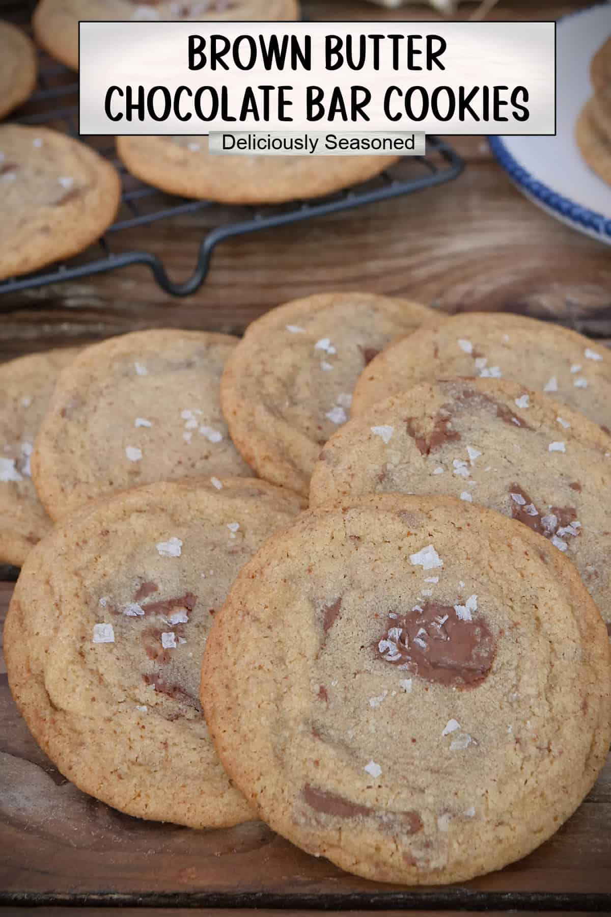 A wood surface with a stack of brown butter chocolate bar cookies and a title overlay at the top.