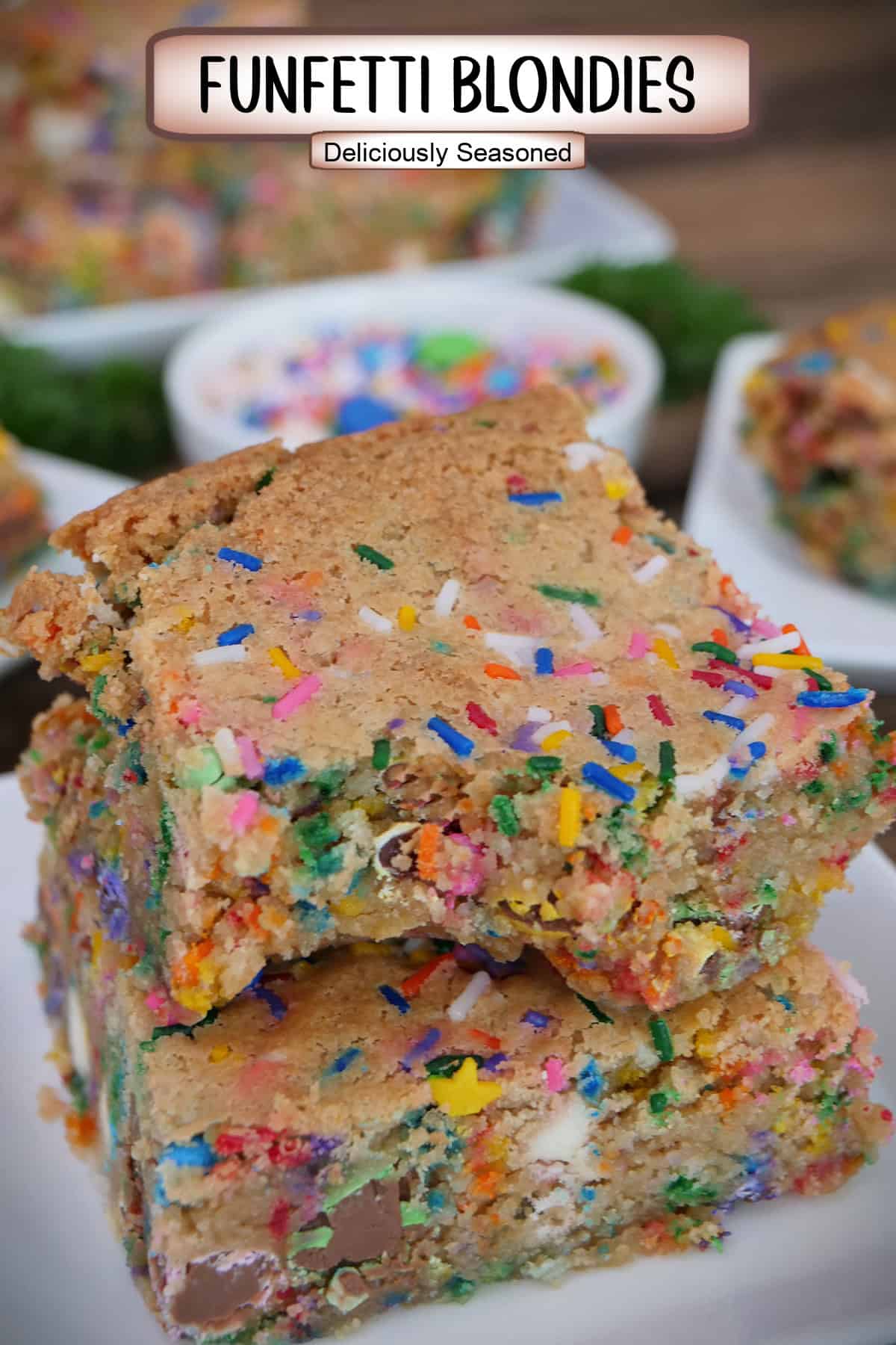 A white plate with two funfetti blondies on it with a bite out of the top blondie, and a title overlay at the top.
