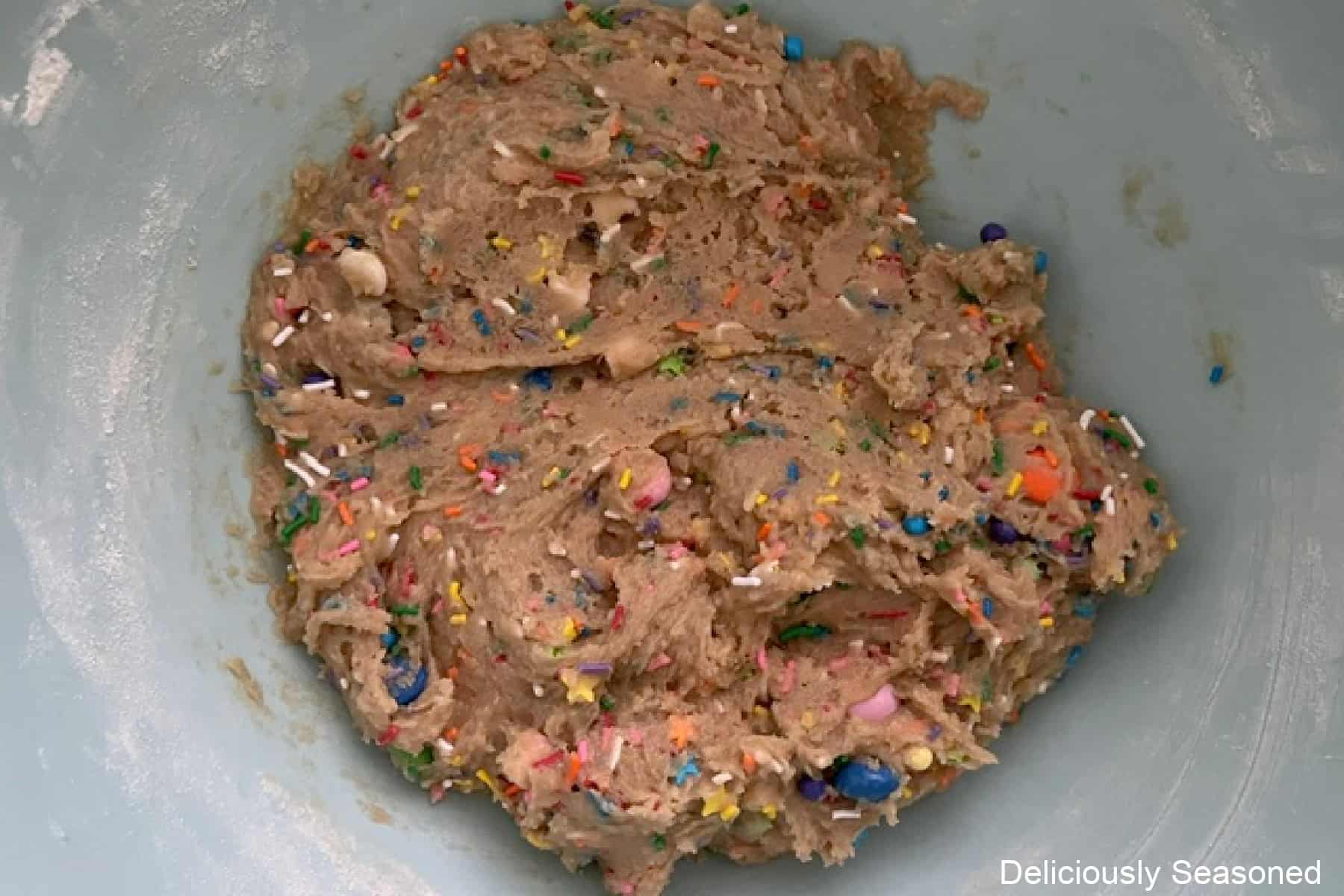 A mixing bowl with funfetti blondie batter in it.