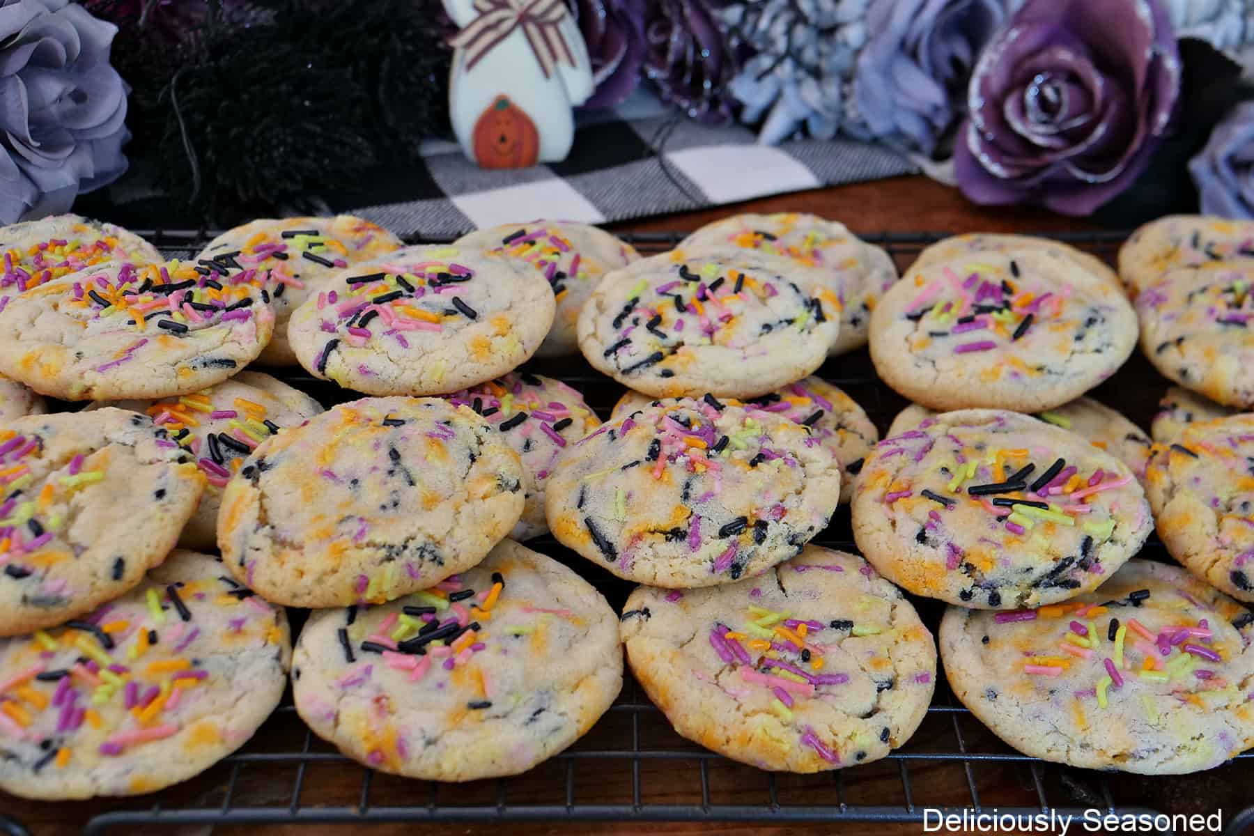 A stack of Halloween sugar cookies on a wire rack.