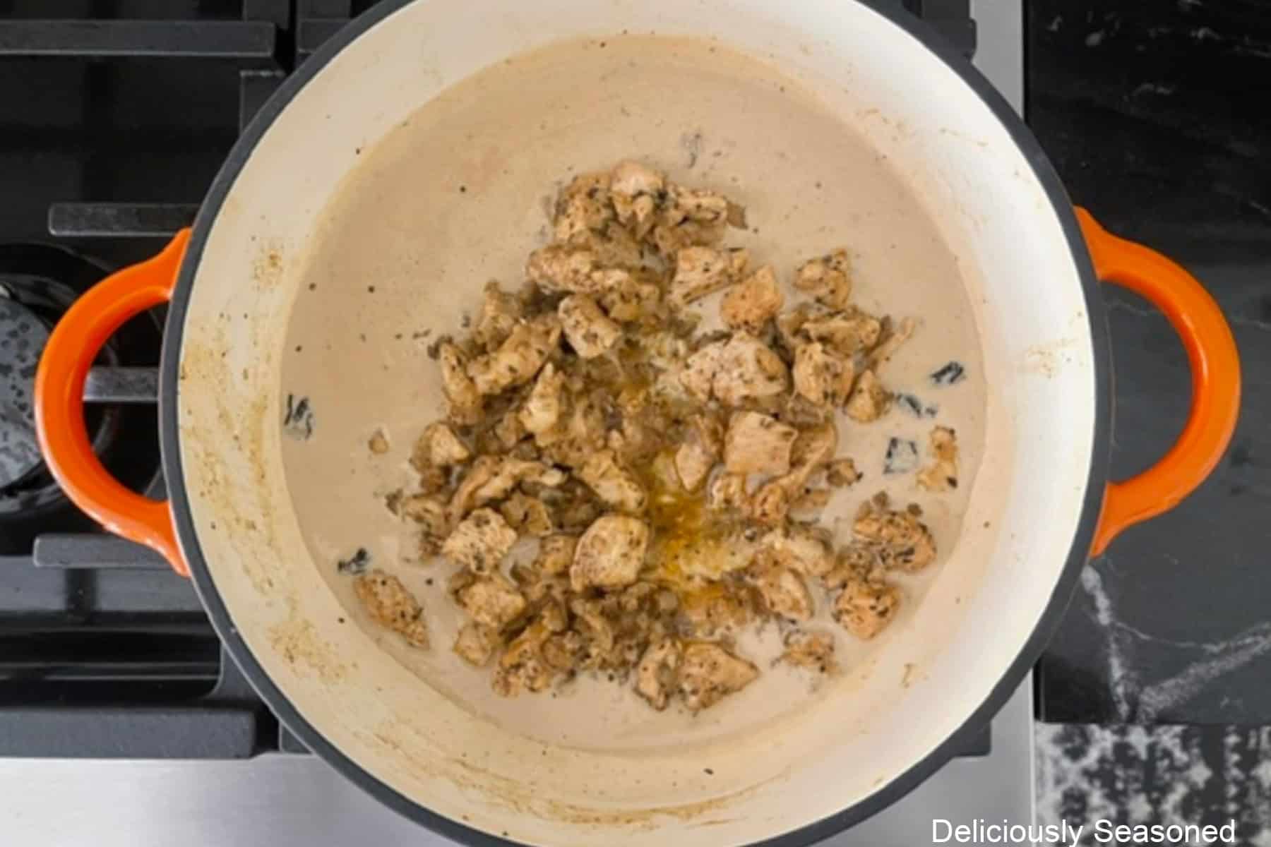 Seasoned chicken mixture added to a creamy Parmesan sauce.