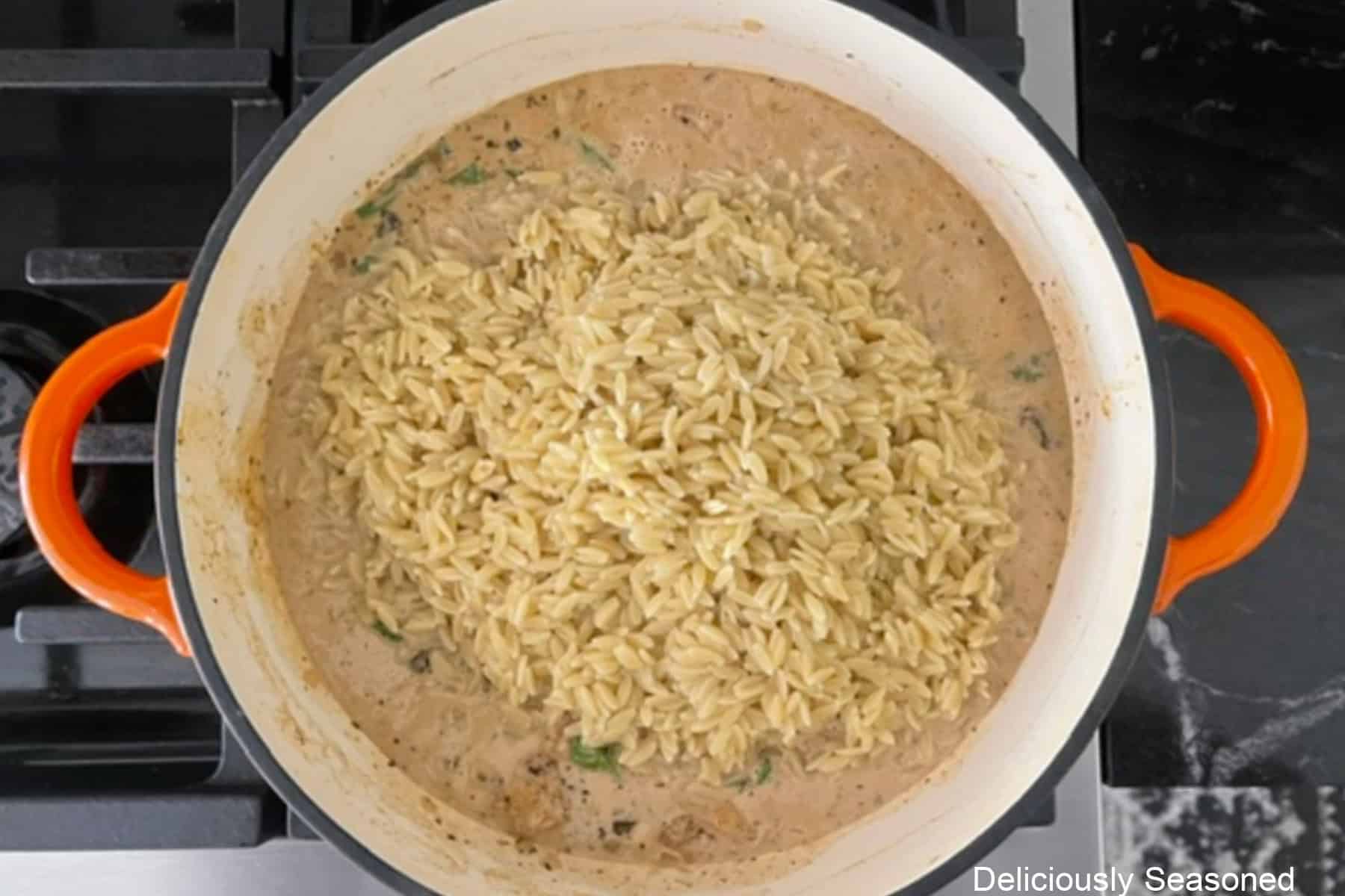 Cooked orzo added to the Tuscan chicken mixture.
