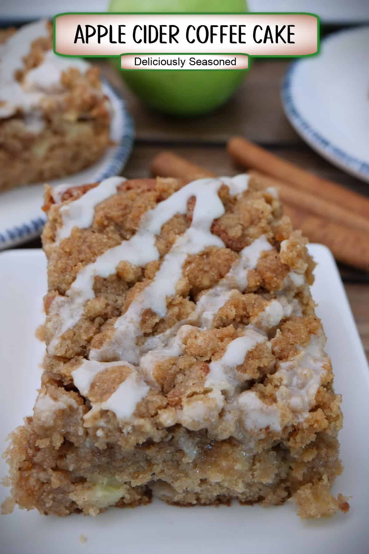 A white square plate with a serving of apple cider coffee cake on it with a title overlay at the top.