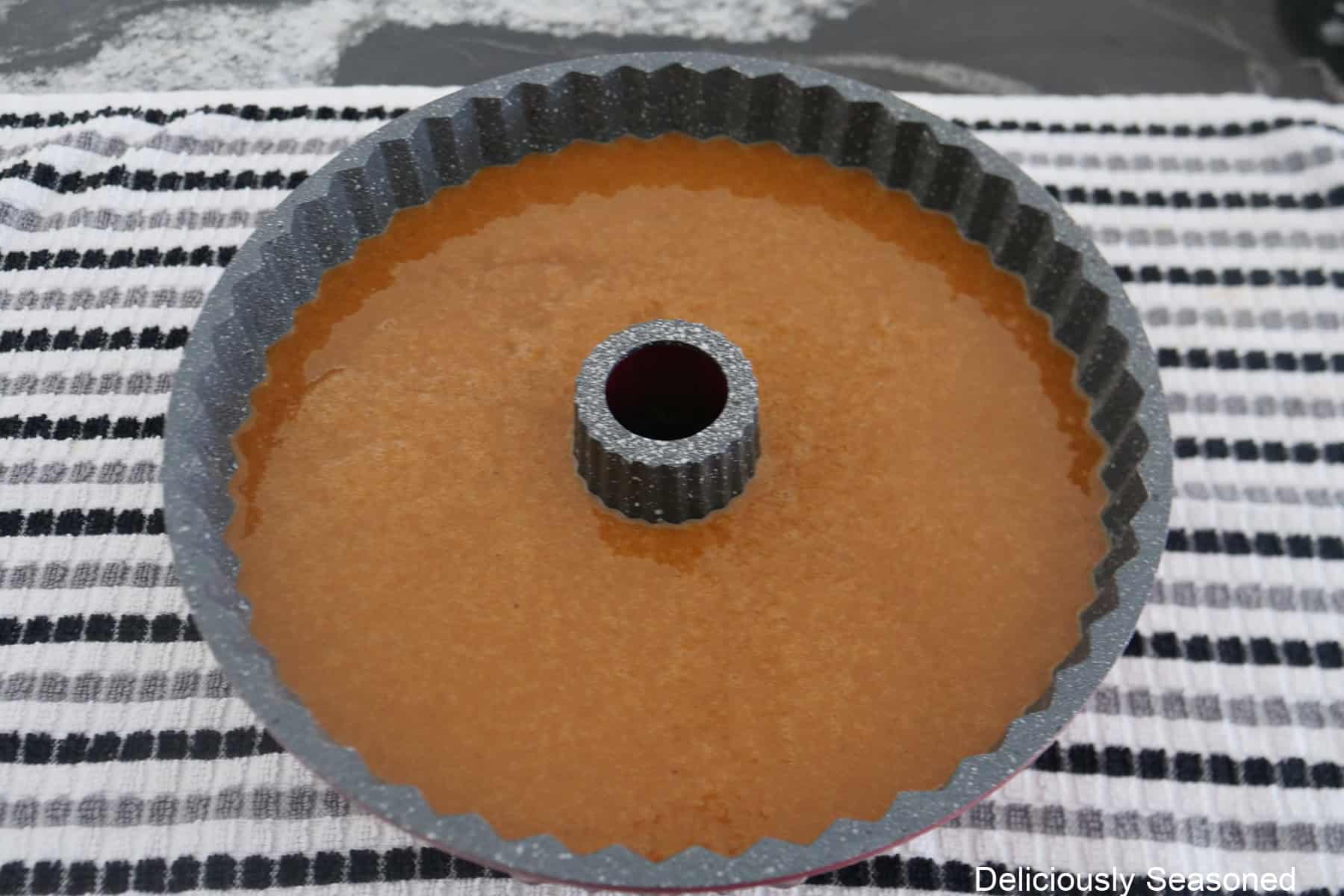 A bundt pan filled with gingerbread cake batter before being baked.